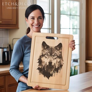 May include: A rectangular wooden cutting board with a handle, featuring a detailed sepia-toned wolf portrait with a forest silhouette. The text "ETCH&DECO" and "LINECRAFT STUDIO" is visible in the upper left corner. The board is held by a person.