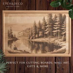 May include: Wooden cutting board with a detailed engraved landscape scene of a person fishing on a lake surrounded by trees. The board has a light wood finish and a recessed edge. The text "ETCH&DECO LINECRAFT STUDIO" is at the top.