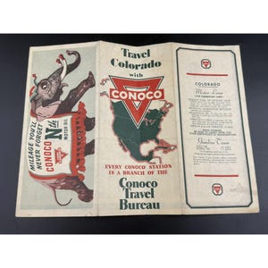 May include: A vintage tri-fold travel brochure for Conoco featuring an illustration of an elephant wearing a blanket with the text Mileage You'll Never Forget Conoco Nth Motor Oil, a map of North America, and Colorado Motor Laws information.