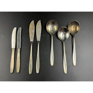 May include: A set of six silver-plated utensils, including two butter knives and four soup spoons.