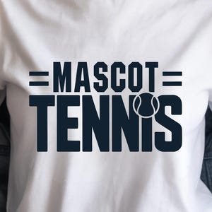 May include: White t-shirt with the navy blue text "MASCOT TENNIS" and a tennis ball graphic. The shirt is a classic crew neck style.