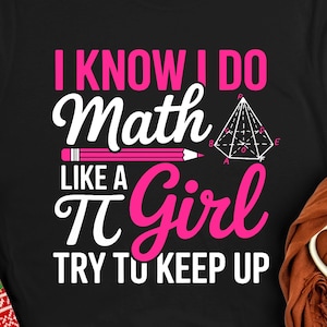 May include: Black t-shirt with the text "I KNOW I DO Math LIKE A Girl TRY TO KEEP UP" in white and pink. A pencil and geometric shape are also featured in the design. Red Christmas socks are visible on the left.