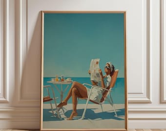 Puede incluir: Una impresión artística enmarcada muestra a una persona leyendo un periódico en una silla de playa. Una pequeña mesa con bebidas está cerca, y la escena se desarrolla contra un cielo azul claro. La obra de arte tiene un estilo vintage y minimalista.