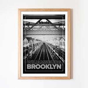 May include: Black and white framed print of the Williamsburg Bridge in Brooklyn, New York. The image features the bridge's metal structure and train tracks, with the words "WILLIAMSBURG BROOKLYN" in bold text at the bottom.
