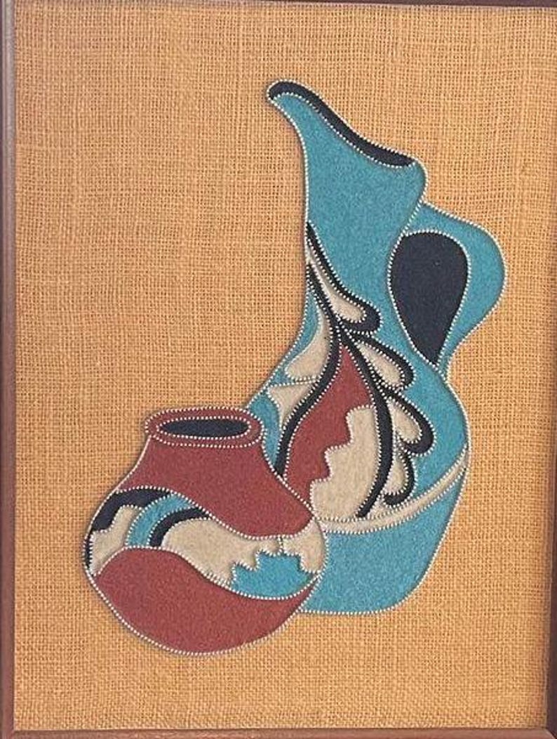 May include: Two pottery vessels, one blue and one red, with intricate designs, are displayed against a burlap background.