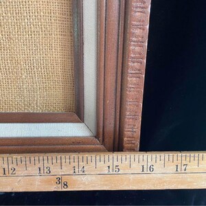 May include: A close-up of a wooden picture frame with a burlap background. The frame is 18 1/2 inches long.