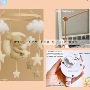 May include: A baby mobile with a beige bunny and a smaller bunny hugging on a crescent moon, with star and cloud accents. Includes a wooden arm and music box. The text "WITH ARM AND MUSIC BOX" is visible.