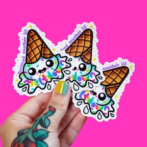 May include: Three die-cut stickers featuring a cartoon melting ice cream cone with a light blue scoop, brown waffle cone, and colorful sprinkles. The text "survived another lil meltdown" is printed in purple around the ice cream illustration.