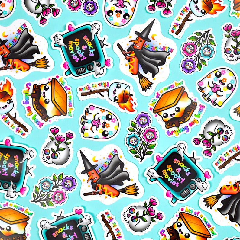 May include: A collection of colorful Halloween-themed stickers on a light blue background. The stickers feature various designs, including a witch on a broom, ghosts, skulls with flowers, a s'more, and a TV with the text "snacks & spooky movies".