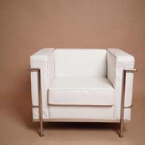 May include: A white leather armchair with a chrome frame. The chair has a simple, modern design.