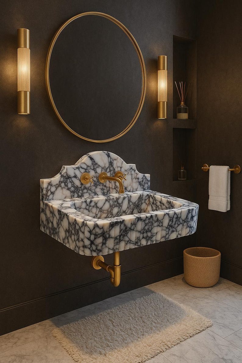 May include: A marble sink with a white and gray pattern, gold fixtures, and a matching round mirror. The bathroom features gold sconces, a towel rack, and a woven basket. The overall design is luxurious and modern.