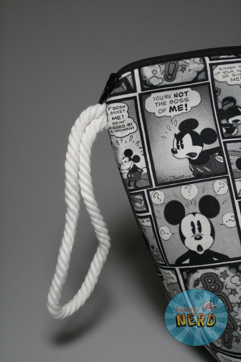 May include: Black and white zippered pouch with a white rope handle. The pouch features a comic book design with Mickey Mouse and the text "You're not the boss of me!"