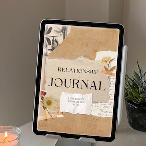 May include: A digital Relationship Journal on a tablet, displayed on a silver stand. The journal cover features a collage design with the title "Relationship Journal" and the text "A space to reflect, remember, and grow together."