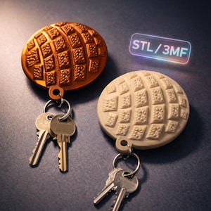 May include: Two keychains with keys. One is bronze, the other is off-white. Both have a circular design with a grid pattern. The keychains are attached to key rings with several keys. The text "STL/3MF" is in a glowing rectangle.