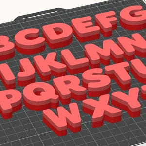 May include: A collection of red 3D alphabet letters, from A to Z, arranged on a dark gray grid. Each letter has a shadow effect, giving them a raised appearance. The letters are evenly spaced and clearly visible.