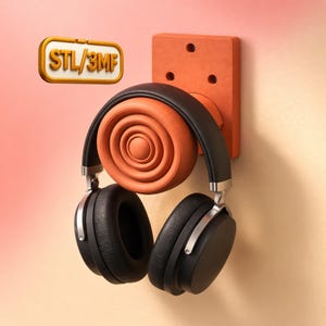 May include: A pair of black over-ear headphones hanging on an orange wall mount. The mount has a circular holder and a rectangular base with three holes. A gold-colored sign with the text "STL/3MF" is in the upper left corner.