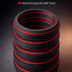 May include: A black pen holder with a tire design, featuring red stripes. The text "TYRE PEN HOLDER" and "MULTICOLOUR 3MF FILE" are visible. The pen holder is stacked, with a dark background.