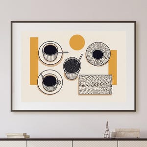 May include: A framed art print featuring a minimalist illustration of coffee cups, saucers, and a container of coffee beans. The artwork has a cream background with orange geometric shapes and black line art. The print hangs above a white cabinet.