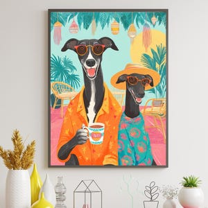 May include: Art print featuring two greyhounds in sunglasses and tropical shirts. One holds a mug with the word "Mum" on it. The background includes palm trees, a yellow sun, and hanging lanterns. The artwork is framed and displayed on a wooden cabinet.