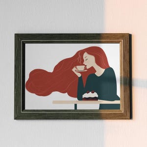 May include: Framed art print featuring a woman with long red hair, sipping from a cup. She is seated at a table with a cake. The artwork is in a dark wooden frame, mounted on a white wall, with sunlight casting shadows.