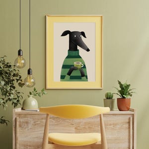 May include: Framed art print featuring a stylized black dog wearing a green and white striped sweater, holding a coffee cup. The artwork has a yellow border and is set against a neutral background. The word "yum" is on the cup.