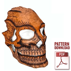 May include: A brown skull mask with black stitching and cut-out eye sockets and mouth. The mask has a textured appearance and is set against a white background. The words "PATTERN DOWNLOAD" and a PDF icon are visible.