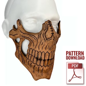 May include: A brown, carved skull mask with detailed teeth and bone structure. The mask is displayed on a white mannequin head. The image includes the text "PATTERN DOWNLOAD" and a PDF icon.