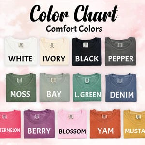 May include: A Comfort Colors color chart featuring thirteen t-shirts in various shades: white, ivory, black, pepper, moss, bay, light green, denim, watermelon, berry, blossom, yam, and mustard. Each shirt displays its corresponding color name in text.