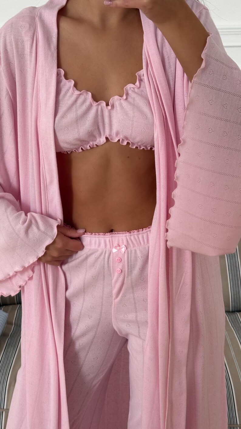 May include: A set of three ceramic mugs with a speckled, matte finish. The mugs are in shades of cream, light gray, and dark gray. Each mug has a simple, minimalist design and a rounded handle. The mugs are stacked on top of each other.