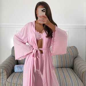 May include: A set of three ceramic nesting bowls in shades of blue, green, and white. The bowls feature a speckled glaze and a simple, modern design. The largest bowl measures approximately 6 inches in diameter.