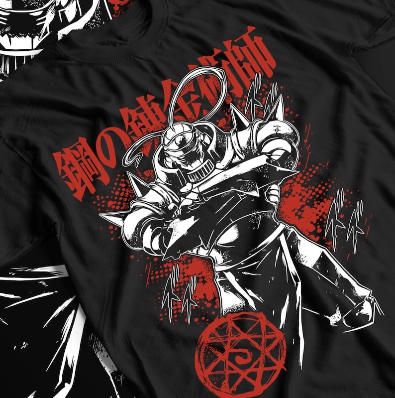 May include: Black t-shirt featuring a detailed illustration of a character in a suit of armor, with red Japanese text and accents. The design includes a red alchemic circle at the bottom. The artwork is in a bold, graphic style.