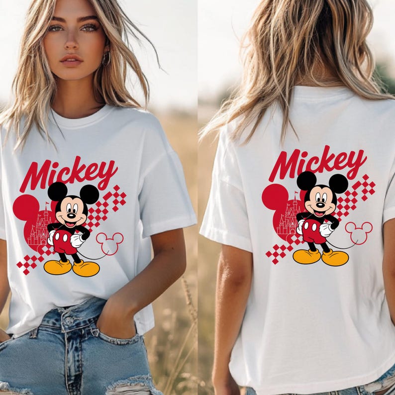 May include: White t-shirt featuring a Mickey Mouse graphic. The design includes the word "Mickey" in red script, a cartoon image of Mickey Mouse, and a red castle silhouette. The shirt is a casual style.