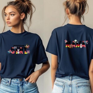 May include: Two navy blue t-shirts with a Mickey Mouse themed design. The front shirt says "Birthday Girl" with Mickey Mouse characters. The back shirt says "Mama" with Mickey Mouse characters.