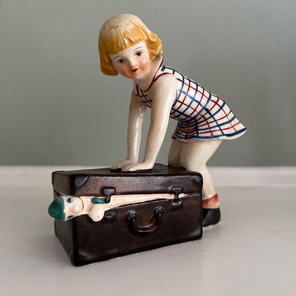 Vintage Ceramic Figurine Girl Closing Trunk with Doll