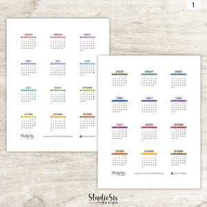 May include: Two white sheets of paper with colorful monthly calendars for the year 2006. Each month is labeled with a different color. The Studio Sis design logo is at the bottom.