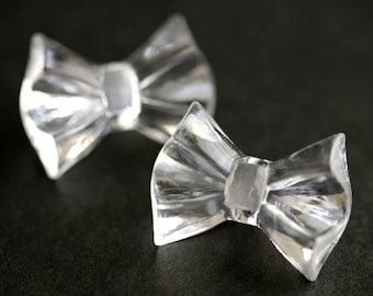 Two (2) Clear Bow Buttons. Clear Buttons. Bow Tie Buttons. Clear Buttons. Clear Acrylic Buttons. Clear Plastic Buttons. 19mm x 25mm