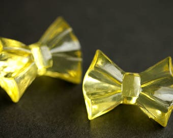 Two (2) Yellow Bow Buttons. Yellow Buttons. Bow Tie Buttons. Clear Buttons. Clear Acrylic Buttons. Clear Plastic Buttons. 19mm x 25mm