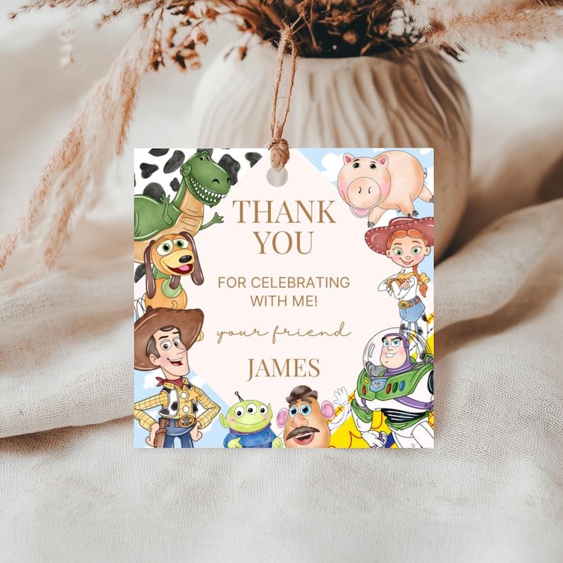 May include: Square gift tag featuring characters from the Toy Story movie. The tag has a light blue background with clouds and the text "THANK YOU FOR CELEBRATING WITH ME!" and "your friend JAMES". The tag is tied with a natural twine.