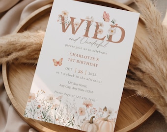 May include: A white invitation card with the text "WILD and Onederful" in a brown font, celebrating Charlotte's 1st birthday. The card features floral and butterfly illustrations, with pumpkins at the bottom. The date is October 26, 2025.