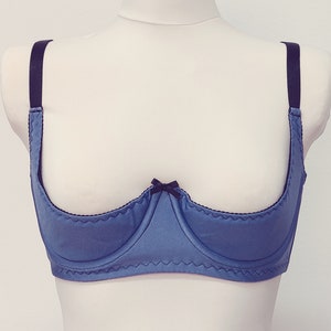 lavender blue quarter cup bra with black straps, trim and bow