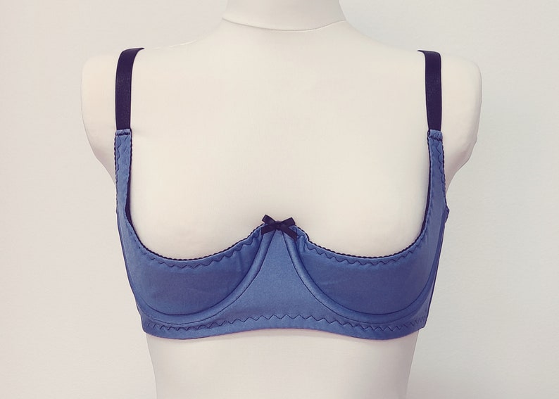 lavender blue quarter cup bra with black straps, trim and bow