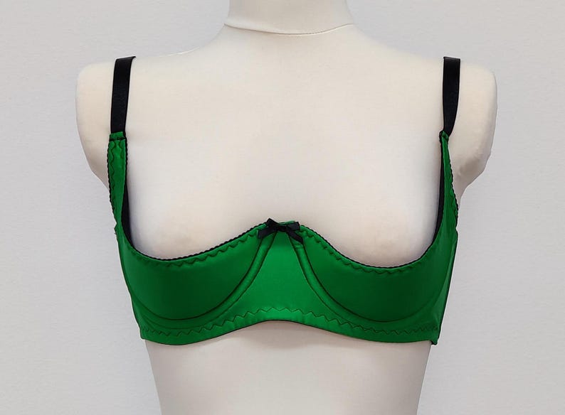 emerald green Gina quarter cup bra with black straps, trim and bow.