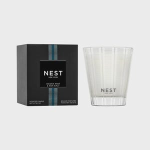 May include: A black and white candle jar with a clear glass lid. The jar has a label that reads "NEST NEW YORK OCEAN MIST & SEA SALT". The candle is a scented candle and is 6.1 ounces.
