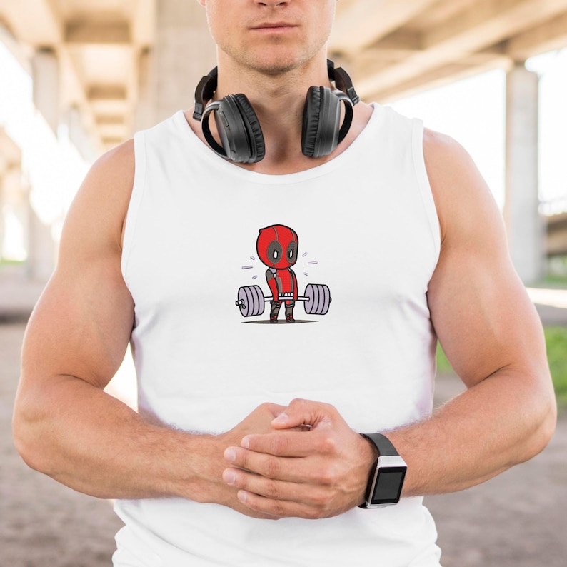 May include: White tank top with a cartoon image of Deadpool lifting a barbell. The image is in red, black, and gray.