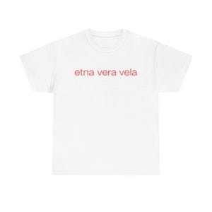 May include: A white t-shirt with the red text "etna vera vela" printed across the chest. The shirt is made of a soft material and has a classic crew neck design. The text is in a simple, sans-serif font.