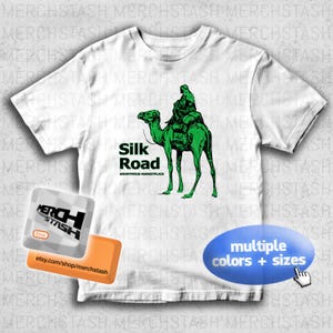 May include: White t-shirt featuring a green illustration of a camel carrying a person, with the text "Silk Road" and "Anonymous Marketplace". The design is available in multiple colors and sizes.