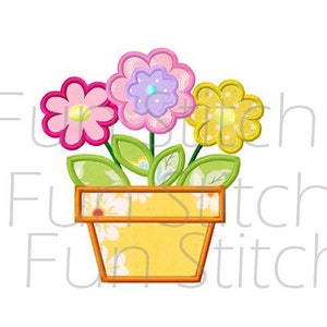May include: A yellow flower pot with three flowers in it. The flowers are pink, purple, and yellow. The pot has a white and yellow floral pattern.