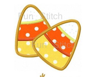 May include: Two yellow, orange, and white candy corn shapes with white polka dots. The candy corn shapes are outlined in gold.
