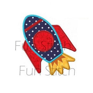 May include: A colorful rocket ship design with a red body, blue polka-dot accents, and yellow flames. The rocket has red wings and a blue border. The text "Fun Stitch" is visible in the image.