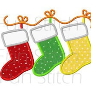 May include: Three Christmas stockings hanging from a string with a bow on each. The stockings are red, green, and yellow with white polka dots.